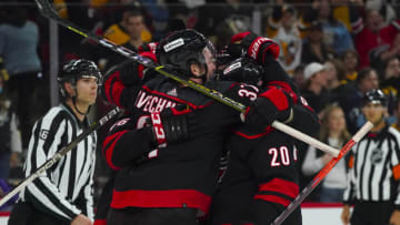 Mar 4, 2022; Raleigh, North Carolina, USA; Carolina Hurricanes right wing Andrei Svechnikov (37) celebrates his game-winning goal with left wing Teuvo Teravainen (86) and center Sebastian Aho (20) against the Pittsburgh Penguins during overtime at PNC Arena. Mandatory Credit: James Guillory-USA TODAY Sports