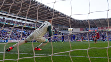 CARDIFF, WALES - APRIL 21: James Milner of Liverpool sends Neil Etheridge of Cardiff City the wrong way from the penalty spot during the Premier League match between Cardiff City and Liverpool FC at Cardiff City Stadium on April 21, 2019 in Cardiff, United Kingdom. (Photo by Mike Hewitt/Getty Images)