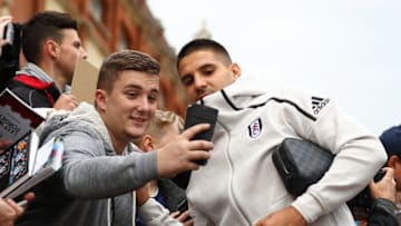 LONDON, ENGLAND - OCTOBER 27: Aleksandar Mitrovic of Fulham poses for a selfie with a fan as he arrives at the stadium prior to the Premier League match between Fulham FC and AFC Bournemouth at Craven Cottage on October 27, 2018 in London, United Kingdom. (Photo by Clive Rose/Getty Images)