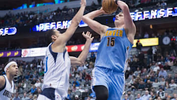 Dec 12, 2016; Dallas, TX, USA; Denver Nuggets forward Nikola Jokic (15) shoots over Dallas Mavericks center Salah Mejri (50) during the second half at the American Airlines Center. The Mavericks defeat the Nuggets 112-92. Mandatory Credit: Jerome Miron-USA TODAY Sports