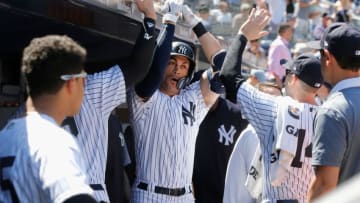 NEW YORK, NY - JUNE 16: Giancarlo Stanton #27 of the New York Yankees celebrates his fifth inning home run against the Tampa Bay Rays with his teammates in the dugout at Yankee Stadium on June 16, 2018 in the Bronx borough of New York City. (Photo by Jim McIsaac/Getty Images)