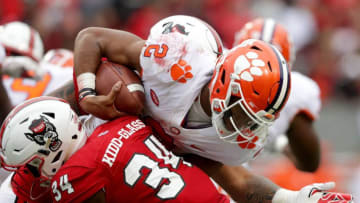 RALEIGH, NC - NOVEMBER 04: Teammates Tim Kidd-Glass #34 of the North Carolina State Wolfpack tackles Kelly Bryant #2 of the Clemson Tigers during their game at Carter Finley Stadium on November 4, 2017 in Raleigh, North Carolina. (Photo by Streeter Lecka/Getty Images)