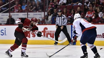 Apr 2, 2016; Glendale, AZ, USA; Arizona Coyotes center Tobias Rieder (8) shoots past Washington Capitals defenseman Dmitry Orlov (9) during the second period at Gila River Arena. Mandatory Credit: Joe Camporeale-USA TODAY Sports