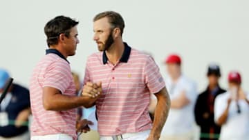 JERSEY CITY, NJ - SEPTEMBER 29: Dustin Johnson and Brooks Koepka of the U.S. Team celebrate defeating Jhonattan Vegas of Venezuela and the International Team and Adam Scott of Australia and the International Team 3