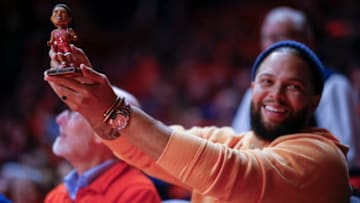 CHAMPAIGN, IL - JANUARY 30: Former NBA and Illinois Fighting Illini player Deron Williams holds up his bobble head during the game against the Rutgers Scarlet Knights at State Farm Center on January 30, 2018 in Champaign, Illinois. (Photo by Michael Hickey/Getty Images)