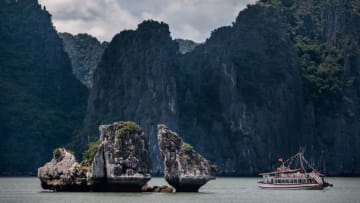 QUANG NINH, VIETNAM - MAY 31: Junk boats carry tourists touring Ha Long Bay, after the Vietnamese government eased the lockdown following the coronavirus disease (COVID-19) outbreak, on May 31, 2020 in Ha Long, Quang Ninh Province, Vietnam. Though some restrictions remain in place, Vietnam has lifted the ban on domestic travel, certain entertainment facilities and non-essential businesses to revive its economy. As of May 31, Vietnam has confirmed 328 cases of coronavirus disease (COVID-19 ) with no deaths in the country, 279 fully recovered and no new case caused by community transmission for 46 days. (Photo by Linh Pham/Getty Images)