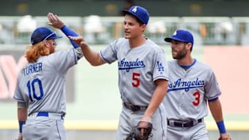 Jun 30, 2016; Milwaukee, WI, USA; Los Angeles Dodgers shortstop Corey Seager (5) celebrates with third baseman Justin Turner (10) after the Dodgers beat the Milwaukee Brewers 8-1 at Miller Park. Mandatory Credit: Benny Sieu-USA TODAY Sports