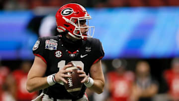 Georgia Bulldogs quarterback JT Daniels (18) drops back to throw a pass in the fourth quarter of the Chick-fil-a Peach Bowl at Mercedes-Benz Stadium in Atlanta on Friday, Jan. 1, 2021. A last-minute field goal sealed a 24-21 win for the Bulldogs, leaving the Bearcats 9-1 on the season.Cincinnati Bearcats Vs Georgia Bulldogs Peach Bowl