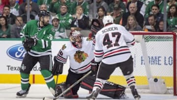 Dec 22, 2015; Dallas, TX, USA; Chicago Blackhawks defenseman Rob Scuderi (47) takes a puck to the face as he defends against Dallas Stars center Vernon Fiddler (38) during the third period at the American Airlines Center. Scuderi leaves the game. The Stars shut out the Blackhawks 4-0. Mandatory Credit: Jerome Miron-USA TODAY Sports