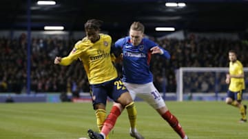 PORTSMOUTH, ENGLAND - MARCH 02: Reiss Nelson of Arsenal competes for the ball with Ronan Curtis of Portsmouth FC during the FA Cup Fifth Round match between Portsmouth FC and Arsenal FC at Fratton Park on March 02, 2020 in Portsmouth, England. (Photo by Robin Jones/Getty Images)