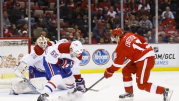 Nov 16, 2014; Detroit, MI, USA; Detroit Red Wings center Pavel Datsyuk (13) takes a shot on Montreal Canadiens goalie Dustin Tokarski (35) defended by defenseman Sergei Gonchar (55) in the third period at Joe Louis Arena. Montreal won 4-1. Mandatory Credit: Rick Osentoski-USA TODAY Sports