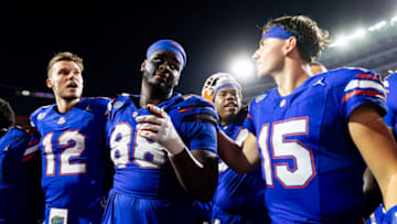 Sep 16, 2023; Gainesville, Florida, USA; Florida Gators quarterback Micah Leon (12), Florida Gators defensive lineman Caleb Banks (88) and Florida Gators quarterback Graham Mertz (15) sing after the game against the Tennessee Volunteers at Ben Hill Griffin Stadium. Mandatory Credit: Matt Pendleton-USA TODAY Sports