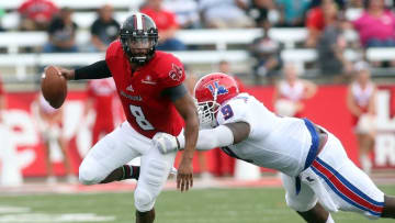 Sep 6, 2014; Lafayette, LA, USA; Louisiana-Lafayette Ragin Cajuns quarterback Terrance Broadway (8) runs with the ball as Louisiana Tech Bulldogs defensive lineman Vernon Butler (9) reaches in for the tackle in the first half at Cajun Field. Mandatory Credit: Crystal LoGiudice-USA TODAY Sports