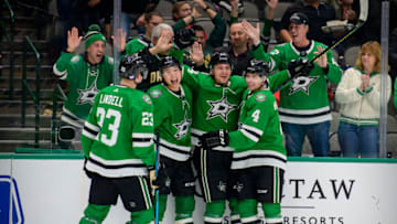 Nov 30, 2021; Dallas, Texas, USA; Dallas Stars defenseman Esa Lindell (23) and left wing Jason Robertson (21) and left wing Roope Hintz (24) and defenseman Miro Heiskanen (4) celebrates a second goal scored by Hintz against the Carolina Hurricanes during the second period at the American Airlines Center. Mandatory Credit: Jerome Miron-USA TODAY Sports