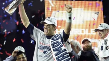 Feb 1, 2015; Glendale, AZ, USA; New England Patriots quarterback Tom Brady (12) hoists the Vince Lombardi Trophy after defeating the Seattle Seahawks in Super Bowl XLIX at University of Phoenix Stadium. Mandatory Credit: Kyle Terada-USA TODAY Sports