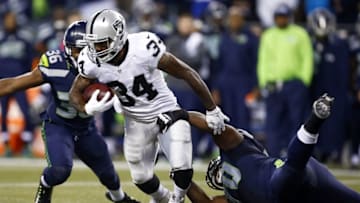Sep 3, 2015; Seattle, WA, USA; Oakland Raiders running back George Atkinson III (34) is tackled for a loss by Seattle Seahawks defensive tackle T.Y. McGill (70) during the third quarter at CenturyLink Field. Mandatory Credit: Joe Nicholson-USA TODAY Sports