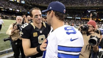 Nov 10, 2013; New Orleans, LA, USA; New Orleans Saints quarterback Drew Brees (9) greets Dallas Cowboys quarterback Tony Romo (9) following their 49-17 victory over the Dallas Cowboys at Mercedes-Benz Superdome. Mandatory Credit: John David Mercer-USA TODAY Sports