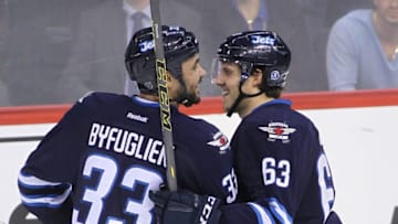 WINNIPEG, MB - JANUARY 3: Ben Chiarot #63 of the Winnipeg Jets is congratulated by teammate Dustin Byfuglien #33 for his first NHL goal in third period action in an NHL game against the Toronto Maple Leafs at the MTS Centre on January 3, 2015 in Winnipeg, Manitoba, Canada. (Photo by Marianne Helm/Getty Images)