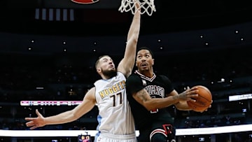 Feb 5, 2016; Denver, CO, USA; Chicago Bulls guard Derrick Rose (1) drives to the net against Denver Nuggets center Joffrey Lauvergne (77) in the first quarter at the Pepsi Center. The Nuggets defeated the Bulls 115-110. Mandatory Credit: Isaiah J. Downing-USA TODAY Sports