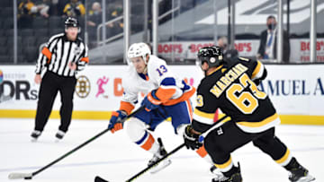 Apr 16, 2021; Boston, Massachusetts, USA; New York Islanders center Mathew Barzal (13) controls the puck while Boston Bruins center Brad Marchand (63) defends during the first period at TD Garden. Mandatory Credit: Bob DeChiara-USA TODAY Sports