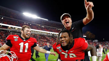 ATHENS, GEORGIA - NOVEMBER 23: Head coach Kirby Smart of the Georgia Bulldogs leaps on the back of Isaiah Wilson #79 as they celebrate their 19-13 win over the Texas A&M Aggies at Sanford Stadium on November 23, 2019 in Athens, Georgia. (Photo by Kevin C. Cox/Getty Images)
