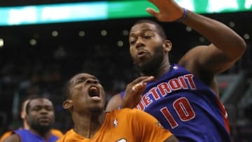 Mar 21, 2014; Phoenix, AZ, USA; Phoenix Suns guard Eric Bledsoe (2) drwas the foul on Detroit Pistons forward Greg Monroe (10) in the third quarter at US Airways Center. Mandatory Credit: Rick Scuteri-USA TODAY Sports