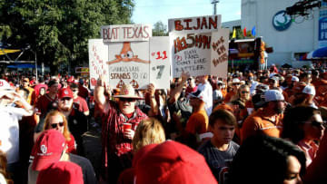 Fans hold signs around the ESPN College GameDay set before the Red River Showdown college football game between the University of Oklahoma Sooners (OU) and the University of Texas (UT) Longhorns at the Cotton Bowl in Dallas, Saturday, Oct. 9, 2021.Ou Vs Texas