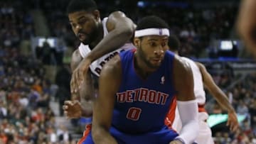 Mar 12, 2014; Toronto, Ontario, CAN; Detroit Pistons center Andre Drummond (0) controls the ball against Toronto Raptors forward/center Amir Johnson (15) during the second half at the Air Canada Centre. Toronto defeated Detroit 101-87. Mandatory Credit: John E. Sokolowski-USA TODAY Sports