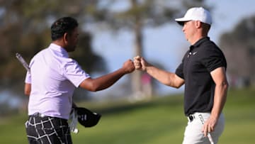 Jan 28, 2021; San Diego, California, USA; Alex Noren (R) bumps fists with Anirban Lahiri (L) after completing their first round of the Farmers Insurance Open golf tournament at Torrey Pines Municipal Golf North Course. Mandatory Credit: Orlando Ramirez-USA TODAY Sports