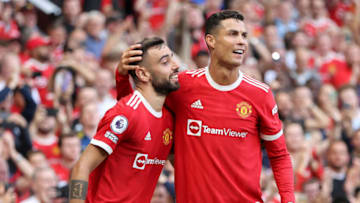 MANCHESTER, ENGLAND - SEPTEMBER 11: Bruno Fernandes of Manchester United celebrates with Cristiano Ronaldo after scoring their side's third goal during the Premier League match between Manchester United and Newcastle United at Old Trafford on September 11, 2021 in Manchester, England. (Photo by Clive Brunskill/Getty Images)