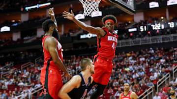 HOUSTON, TEXAS - MARCH 05: Ivica Zubac #40 of the LA Clippers goes up for a shot while defended by James Harden #13 of the Houston Rockets and Danuel House Jr. #4 in third quarter at Toyota Center on March 05, 2020 in Houston, Texas. NOTE TO USER: User expressly acknowledges and agrees that, by downloading and or using this photograph, User is consenting to the terms and conditions of the Getty Images License Agreement. (Photo by Tim Warner/Getty Images)