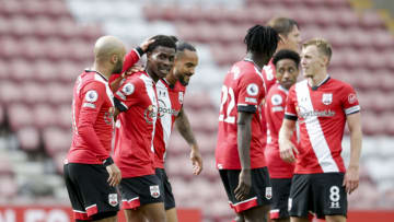 SOUTHAMPTON, ENGLAND - MAY 15: Nathan Redmond of Southampton congratulates team-mate Nathan Tella after he sets up Theo Walcott to score Saints third goal during the Premier League match between Southampton and Fulham at St Mary's Stadium on May 15, 2021 in Southampton, England. (Photo by Robin Jones/Getty Images)