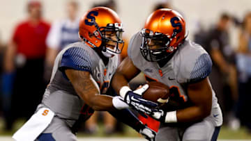 EAST RUTHERFORD, NJ - SEPTEMBER 27: Terrel Hunt #10 of the Syracuse Orange hands off to running back Adonis Ameen-Moore #34 of the Syracuse Orange during their game against the Notre Dame Fighting Irish at MetLife Stadium September 27, 2014 in East Rutherford, New Jersey. (Photo by Jeff Zelevansky/Getty Images)