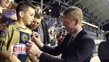 May 20, 2016; Philadelphia, PA, USA; Philadelphia Union head coach Jim Curtin signs an autograph for a young fan after a victory against the D.C. United at Talen Energy Stadium. The Union won 1-0. Mandatory Credit: Derik Hamilton-USA TODAY Sports