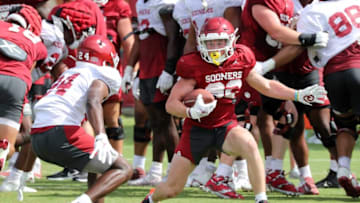 Gentry Williams (24) attempts to tackle Gavin Freeman (82) during drills as the University of Oklahoma Sooners (OU ) hold fall football camp outside Gaylord Family/Oklahoma Memorial Stadium on Aug. 8, 2022 in Norman, Okla. [Steve Sisney/For The Oklahoman]Ou Fall Camp