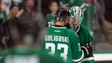 Mar 11, 2016; Dallas, TX, USA; Dallas Stars defenseman Alex Goligoski (33) and goalie Kari Lehtonen (32) celebrate the win over the Chicago Blackhawks at American Airlines Center. The Stars defeat the Blackhawks 5-2. Mandatory Credit: Jerome Miron-USA TODAY Sports