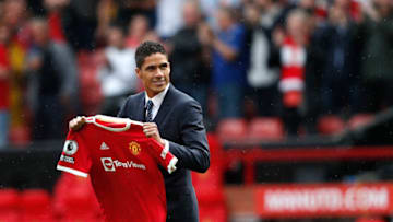 Manchester United's Raphael Varane is presented to the fans ahead of the English Premier League football match between Manchester United and Leeds United at Old Trafford in Manchester, north west England, on August 14, 2021. - RESTRICTED TO EDITORIAL USE. No use with unauthorized audio, video, data, fixture lists, club/league logos or 'live' services. Online in-match use limited to 120 images. An additional 40 images may be used in extra time. No video emulation. Social media in-match use limited to 120 images. An additional 40 images may be used in extra time. No use in betting publications, games or single club/league/player publications. (Photo by Adrian DENNIS / AFP) / RESTRICTED TO EDITORIAL USE. No use with unauthorized audio, video, data, fixture lists, club/league logos or 'live' services. Online in-match use limited to 120 images. An additional 40 images may be used in extra time. No video emulation. Social media in-match use limited to 120 images. An additional 40 images may be used in extra time. No use in betting publications, games or single club/league/player publications. / RESTRICTED TO EDITORIAL USE. No use with unauthorized audio, video, data, fixture lists, club/league logos or 'live' services. Online in-match use limited to 120 images. An additional 40 images may be used in extra time. No video emulation. Social media in-match use limited to 120 images. An additional 40 images may be used in extra time. No use in betting publications, games or single club/league/player publications. (Photo by ADRIAN DENNIS/AFP via Getty Images)