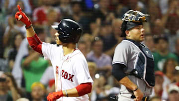 BOSTON, MA - AUGUST 05: Austin Romine #28 of the New York Yankees looks on as Mookie Betts #50 of the Boston Red Sox reacts as he crosses home plate after hitting a solo home run in the fifth inning of a game at Fenway Park on August 5, 2018 in Boston, Massachusetts. (Photo by Adam Glanzman/Getty Images)