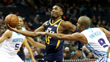 CHARLOTTE, NC - NOVEMBER 30: Donovan Mitchell #45 of the Utah Jazz drives to the basket against Tony Parker #9 of the Charlotte Hornets during their game at Spectrum Center on November 30, 2018 in Charlotte, North Carolina. NOTE TO USER: User expressly acknowledges and agrees that, by downloading and or using this photograph, User is consenting to the terms and conditions of the Getty Images License Agreement. (Photo by Streeter Lecka/Getty Images)