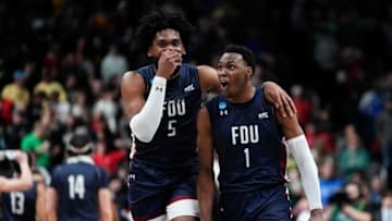 Mar 17, 2023; Columbus, Ohio, USA; Fairleigh Dickinson Knights guard Joe Munden Jr. (1) and forward Ansley Almonor (5) celebrate their 63-58 win over the No. 1 seed Purdue Boilermakers during the first round of the NCAA men’s basketball tournament at Nationwide Arena. Mandatory Credit: Adam Cairns-The Columbus DispatchBasketball Ncaa Men S Basketball Tournament