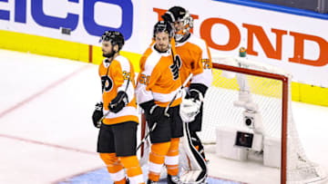 Carter Hart, Justin Braun and Scott Laughton, Philadelphia Flyers (Photo by Elsa/Getty Images)