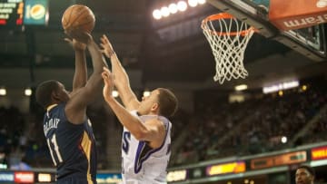 Mar 16, 2016; Sacramento, CA, USA; New Orleans Pelicans guard Jrue Holiday (11) takes a shot over Sacramento Kings guard Seth Curry (30) during the second quarter at Sleep Train Arena. Mandatory Credit: Ed Szczepanski-USA TODAY Sports