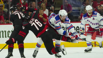 May 18, 2022; Raleigh, North Carolina, USA; Carolina Hurricanes defenseman Brady Skjei (76) and New York Rangers left wing Alexis Lafrenière (13) collide during the second period in game one of the second round of the 2022 Stanley Cup Playoffs at PNC Arena. Mandatory Credit: James Guillory-USA TODAY Sports