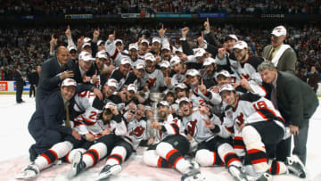 The New Jersey Devils pose with the Stanley Cup after defeating the Mighty Ducks of Anaheim in game seven of the 2003 Stanley Cup Finals at Continental Airlines Arena on June 9, 2003 in East Rutherford, New Jersey. The Devils defeated the Ducks 3-0 to win the Stanley Cup. (Photo by Dave Sandford/Getty Images/NHLI)