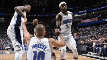 ORLANDO, FL - APRIL 21: Terrence Ross #31 of the Orlando Magic helps Evan Fournier #10 of the Orlando Magic to his feet against the Toronto Raptors during Game Four of Round One of the 2019 NBA Playoffs on April 21, 2019 at Amway Center in Orlando, Florida. NOTE TO USER: User expressly acknowledges and agrees that, by downloading and or using this photograph, User is consenting to the terms and conditions of the Getty Images License Agreement. Mandatory Copyright Notice: Copyright 2019 NBAE (Photo by Fernando Medina/NBAE via Getty Images)