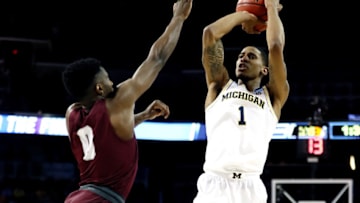 Charles Matthews #1 of the Michigan Wolverines attempts a shot defended by Michael Oguine #0 of the Montana Grizzlies during the first half of the first round of the 2018 NCAA Men's Basketball Tournament at INTRUST Arena on March 15, 2018 in Wichita, Kansas. (Photo by Jamie Squire/Getty Images)