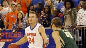 Nov 14, 2014; Gainesville, FL, USA; Florida Gators guard Zach Hodskins (24) dribbles the ball as William & Mary Tribe guard Connor Burchfield (10) defends during the second half at Stephen C. O