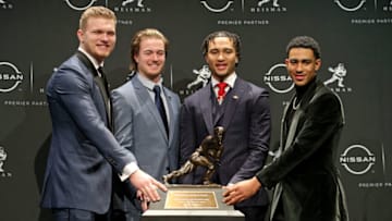 Heisman candidates pose for pictures with the trophy during a press conference. USA Today.