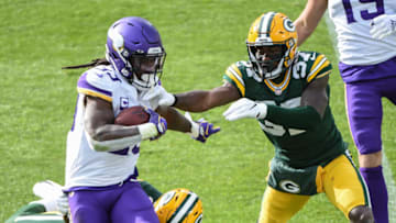 Nov 1, 2020; Green Bay, Wisconsin, USA; Minnesota Vikings running back Dalvin Cook (33) runs past Green Bay Packers cornerback Josh Jackson (37) in the third quarter at Lambeau Field. Mandatory Credit: Benny Sieu-USA TODAY Sports