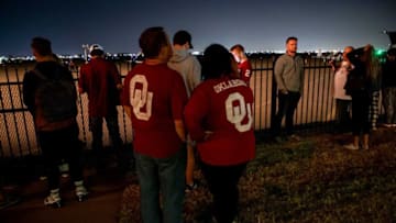 University of Oklahoma fans Dave and Brooke Looper wait at Max Westheimer Airport in Norman, Okla. on Sunday, Dec. 5, 2021, for the potential arrival of Brent Venables.Brent Venables